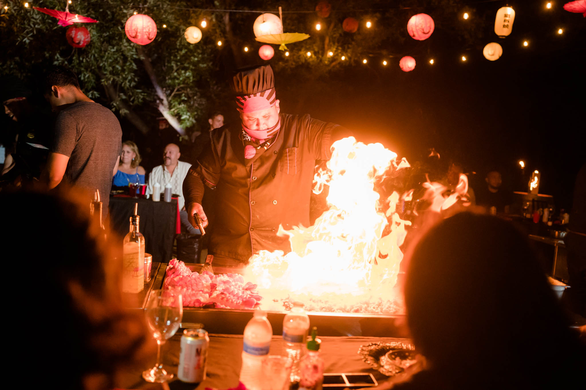 Hibachi Catering chef performing fire tricks during a celebrity rooftop event